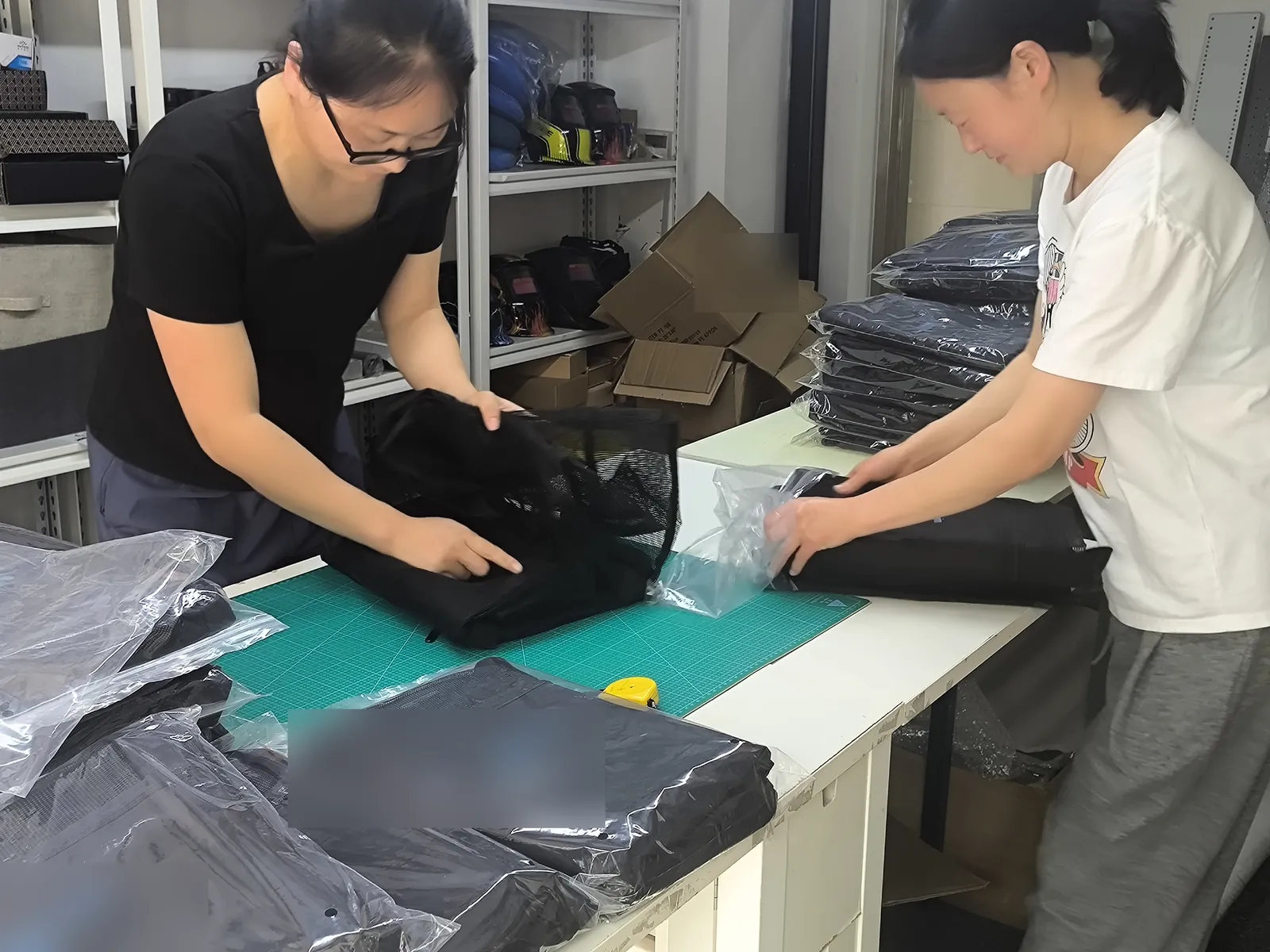 Owl Sourcing team checking garments against the approved sample