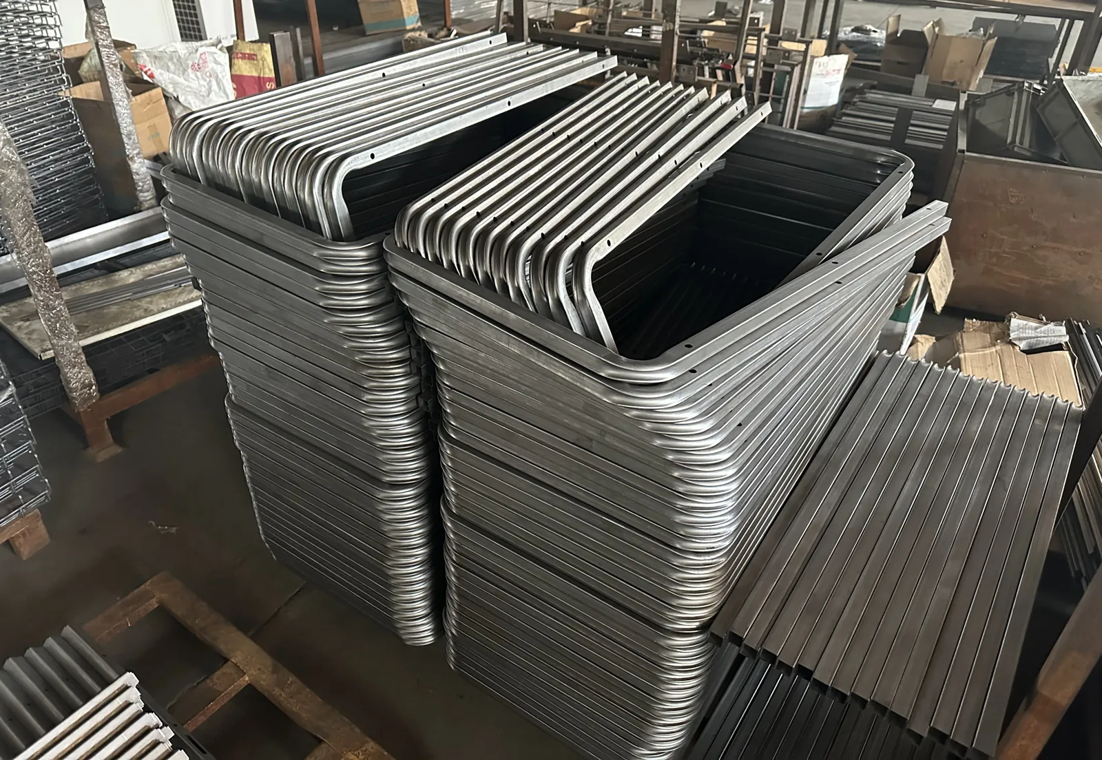 Stacks of bent steel tube frames waiting for welding