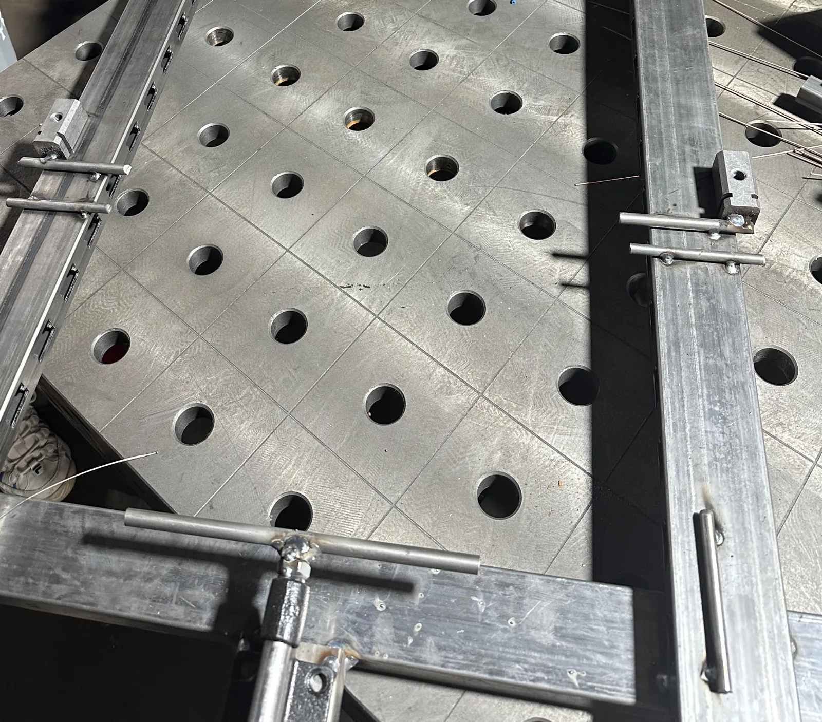 Steel tube frame clamped in a welding fixture on a fixture table