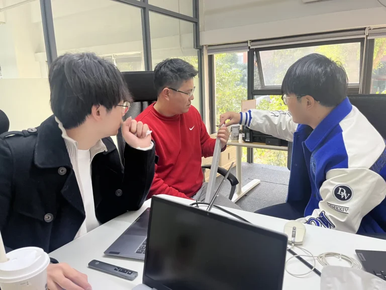 Owl Sourcing team discussing a sourcing project in the Shanghai office